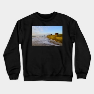 Wooden groynes on the sandy beach on the Norfolk coast Crewneck Sweatshirt